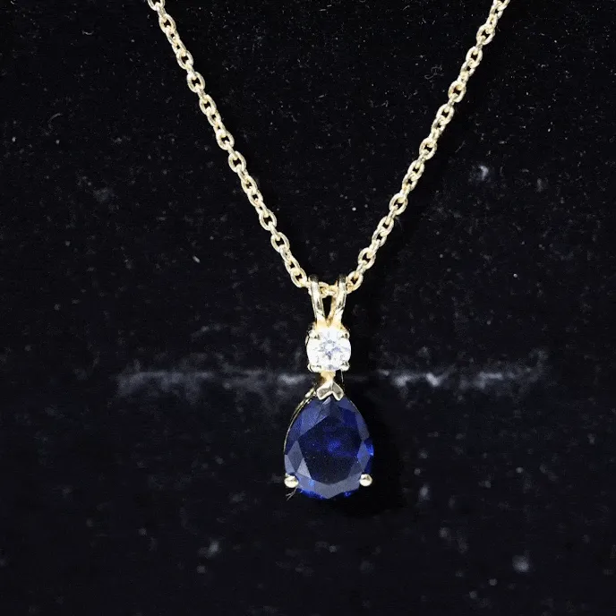 Created Blue Sapphire and Moissanite Modern Teardrop Pendant in Silver